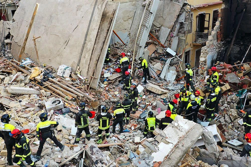 Firefighters work after a four-story apartment building collapsed, following a gas explosion, in Ravanusa on Dec. 12, 2021. (Vigili del Fuoco via AFP)