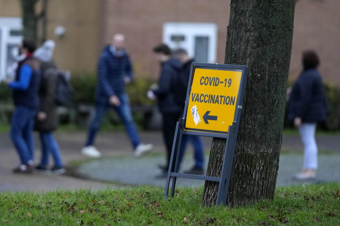 People queue at a vaccination centre in London, Monday, Dec. 13, 2021. (AP)