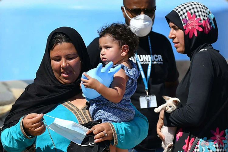 Tunisian migrants disembark from a Guardia Costiera vessel, Lampedusa island, Italy, July 29, 2020. (AFP)