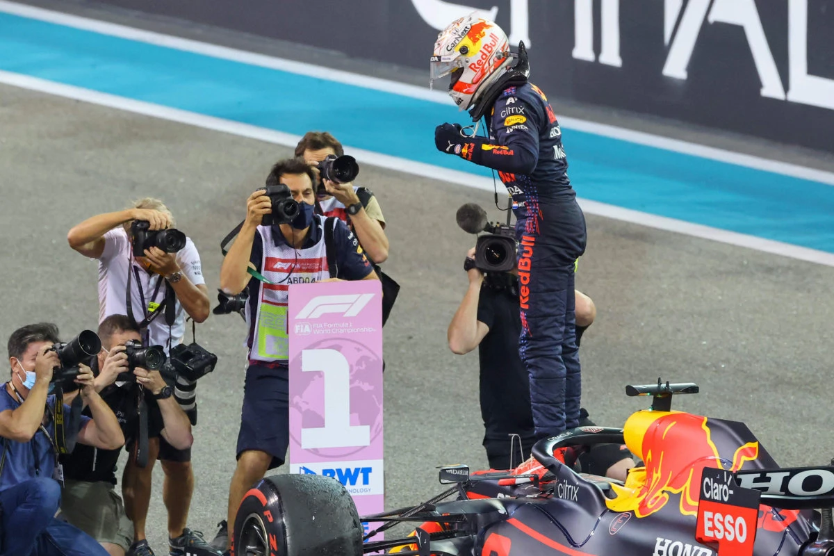 2021 FIA Formula One World Champion Red Bull's Dutch driver Max Verstappen celebrates in the parc ferme of the Yas Marina Circuit after winning the Abu Dhabi Formula One Grand Prix on Dec. 12, 2021. (Photo by Giuseppe Cacace / AFP)
