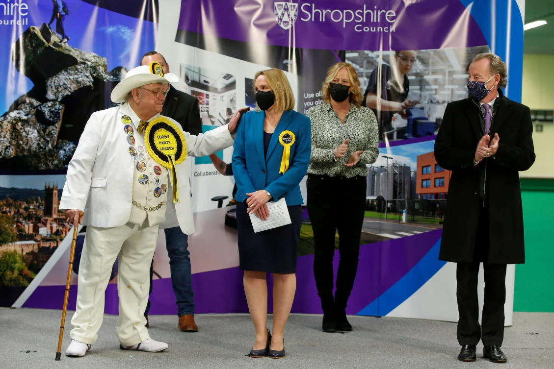 The Official Monster Raving Loony Party candidate, Howling Laud Hope, congratulates Liberal Democrats candidate Helen Morgan after she won the North Shropshire parliamentary seat, in Shrewsbury, Britain December 17, 2021. (Reuters)