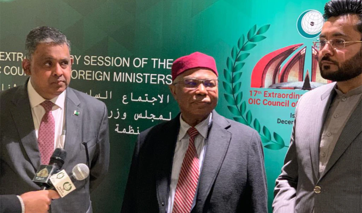 OIC Secretary-General Hissein Brahim Taha, center, arrives ahead of the 17th Extraordinary Session of Organization of Islamic Cooperation. (Twitter @oic_oci)