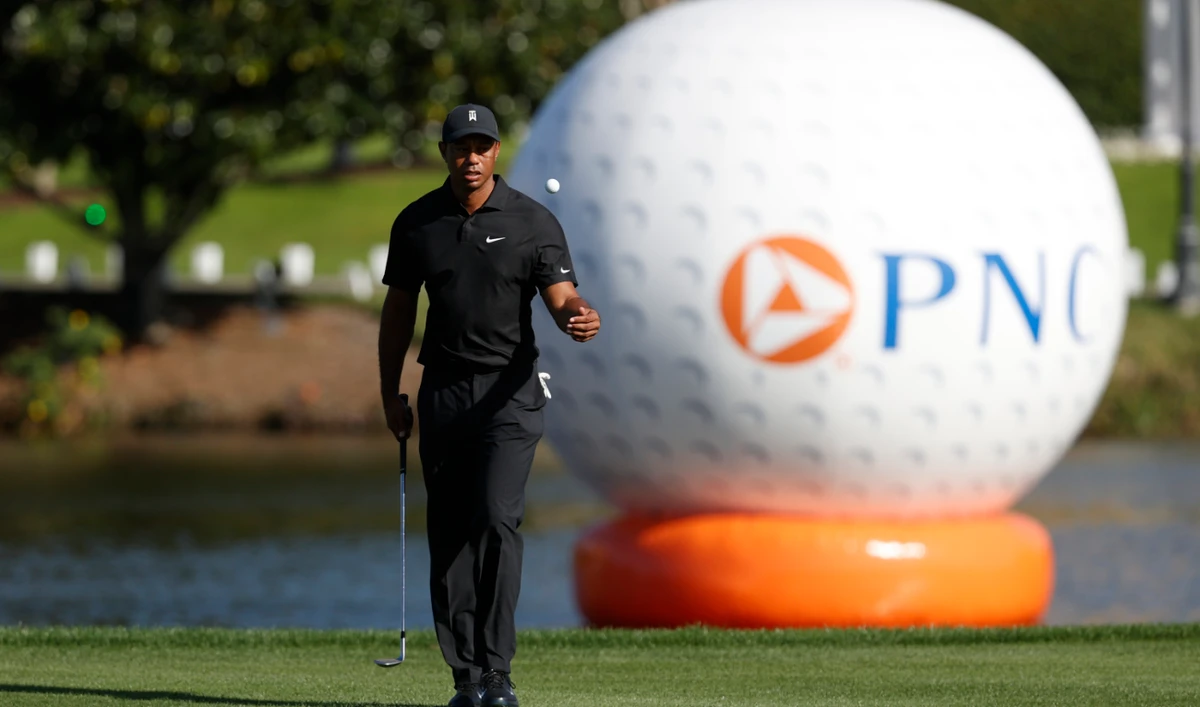 Tiger Woods flips a golf ball on the 18th fairway during the first round of the PNC Championship golf tournament Friday, Dec. 17, 2021, in Orlando, Fla. (AP)