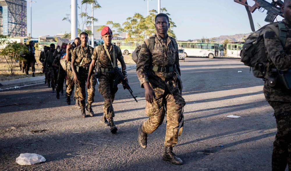 Soldiers from the Ethiopian National Defence Force (ENDF) walk in the streets of Kombolcha, Ethiopia, on December 11, 2021. (AFP)