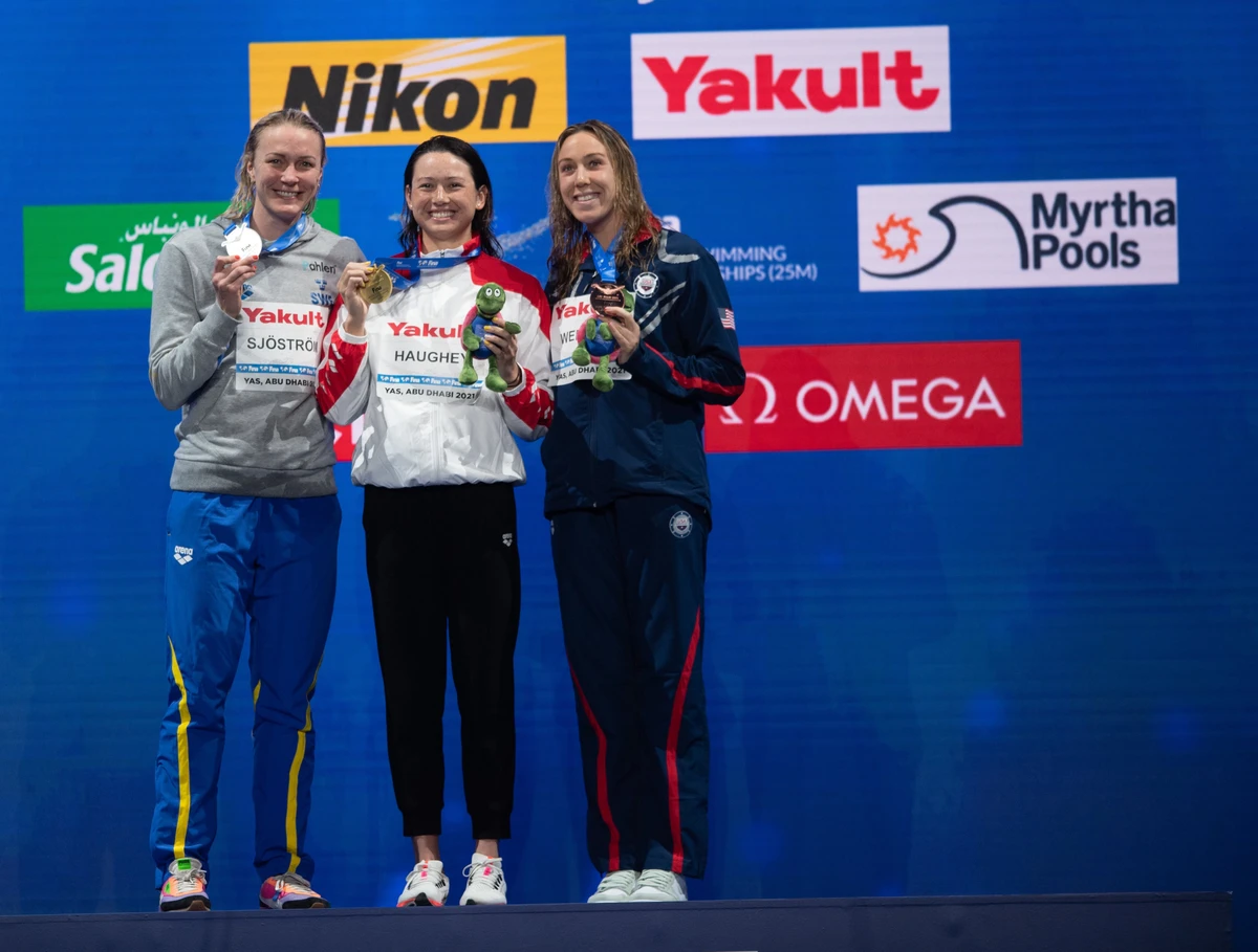 Siobhan Haughey (center) celebrates breaking the world record in the the 100m freestyle at Etihad Arena. (FINA)