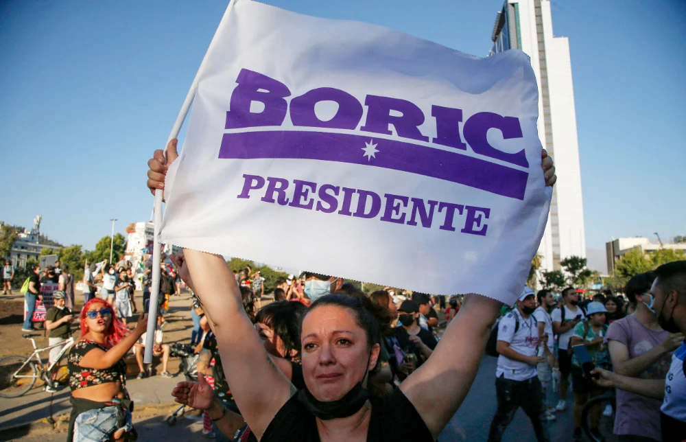 Supporters of Chilean president-elect Gabriel Boric celebrate following the official results of the runoff presidential election, in Santiago, on December 19, 2021. (AFP)