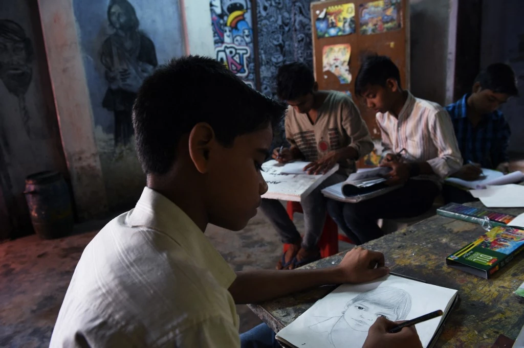 In this picture taken on September 2, 2015, an Indian student draws at an art school in Nangloi, a colony in west New Delhi. (AFP/File)