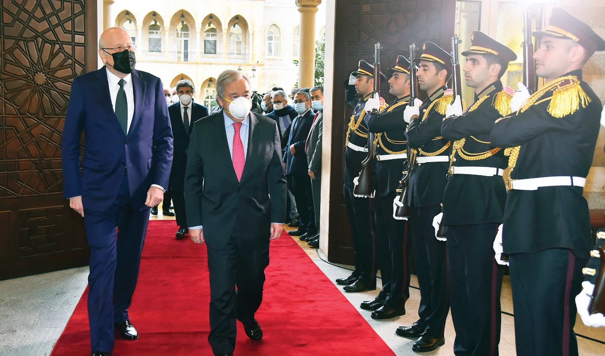 Lebanese Prime Minister Najib Mikati and UN Secretary-General Antonio Guterres review an honor guard at the government house in Beirut on Monday. (AP)