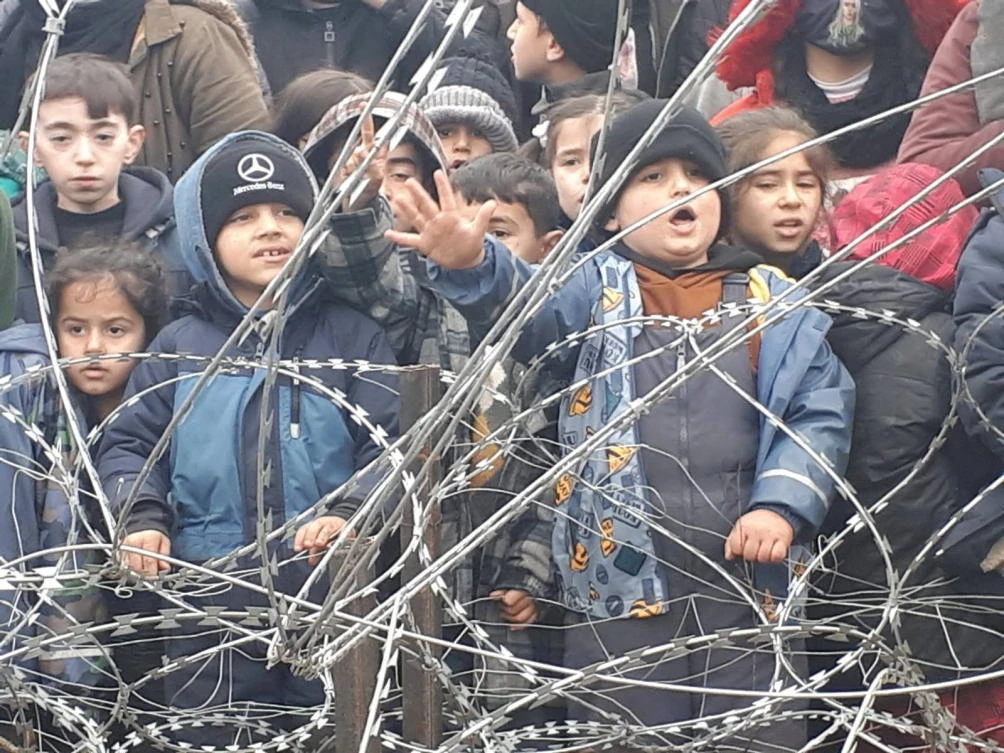 Migrant children gather near the fence on the Poland/Belarus border near Kuznica, Poland, in this video-grab released by the Polish Interior Ministry in November. (Reuters)