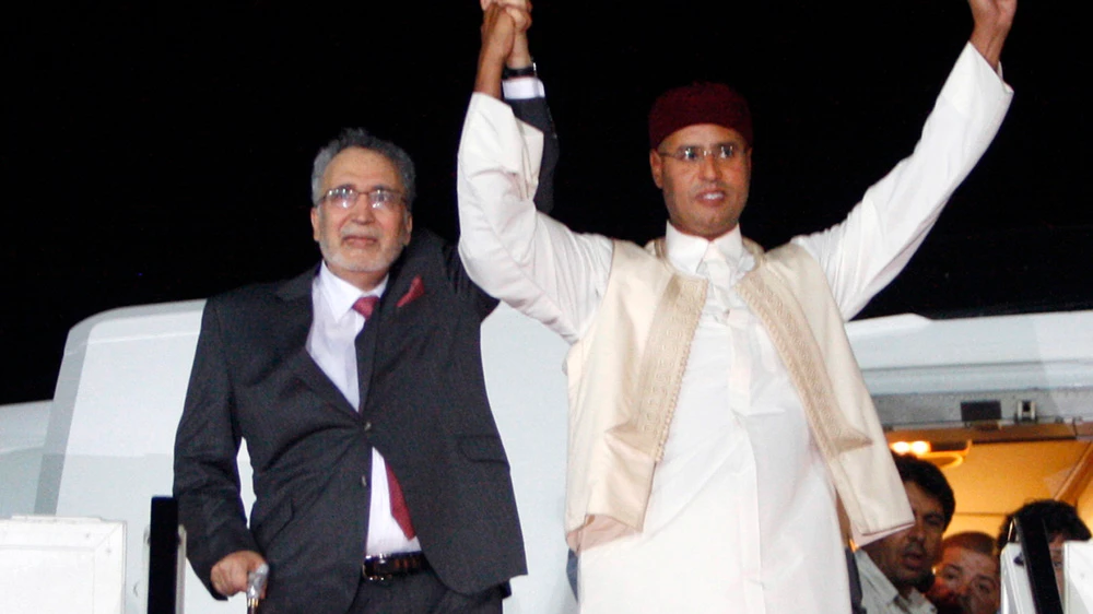 Abdelbaset Ali Al-Megrahi and Saif Al-Islam Gaddafi at Tripoli Airport, Aug. 2009. (AP Photo)