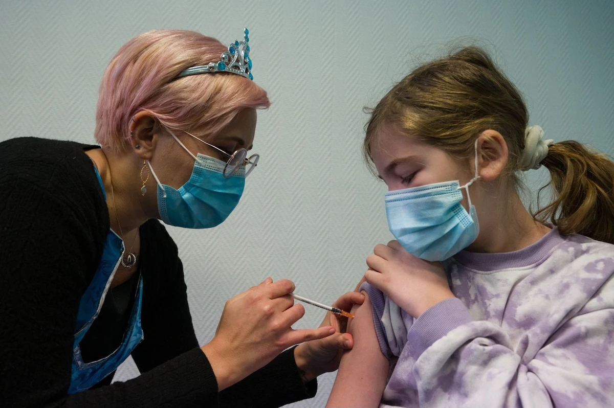 A child receives a dose of Pfizer/BioNTech Covid-19 vaccine at the Clemenceau rehabilitation center in France on December 22, 2021. (AFP)