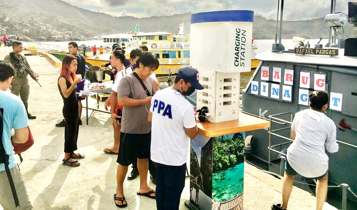 A charging station is provided to residents by the Philippine Navy as they arrive to distribute relief goods in Dinagat islands, southern Philippines, on Tuesday. (AP)