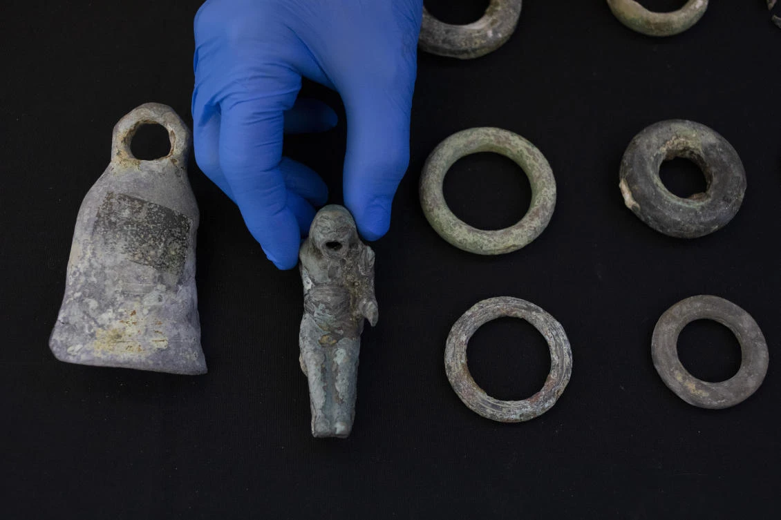 Jacob Sharvit, director of the Marine Archaeology Unit of the Israel Antiquities Authority holds the finds made near the ancient city of Caesarea, dated to Roman and Mamluk periods, around 1,700 and 600 years ago on Wednesday. (AP)