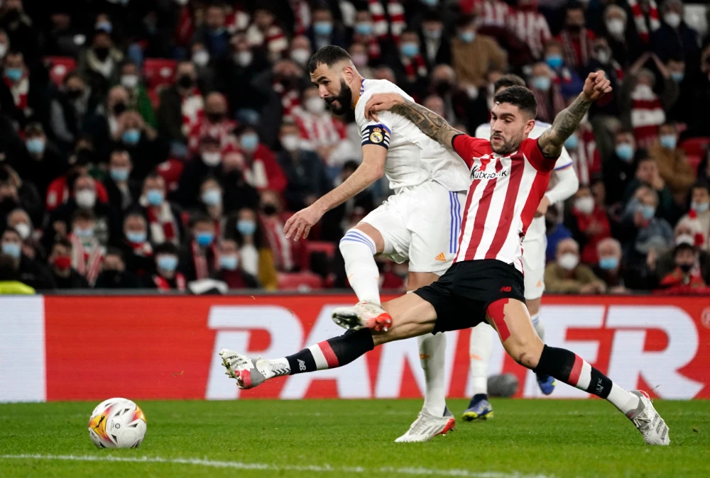 Real Madrid's Karim Benzema in action with Athletic Bilbao's Unai Nunez during their match on December 22, 2021. (Reuters)