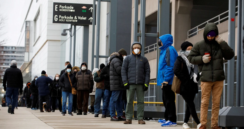 People queue to pick up coronavirus disease (COVID-19) antigen test kits, as the latest Omicron variant emerges as a threat, at Yorkdale Mall in Toronto, Ontario, Canada December 22, 2021. (Reuters)