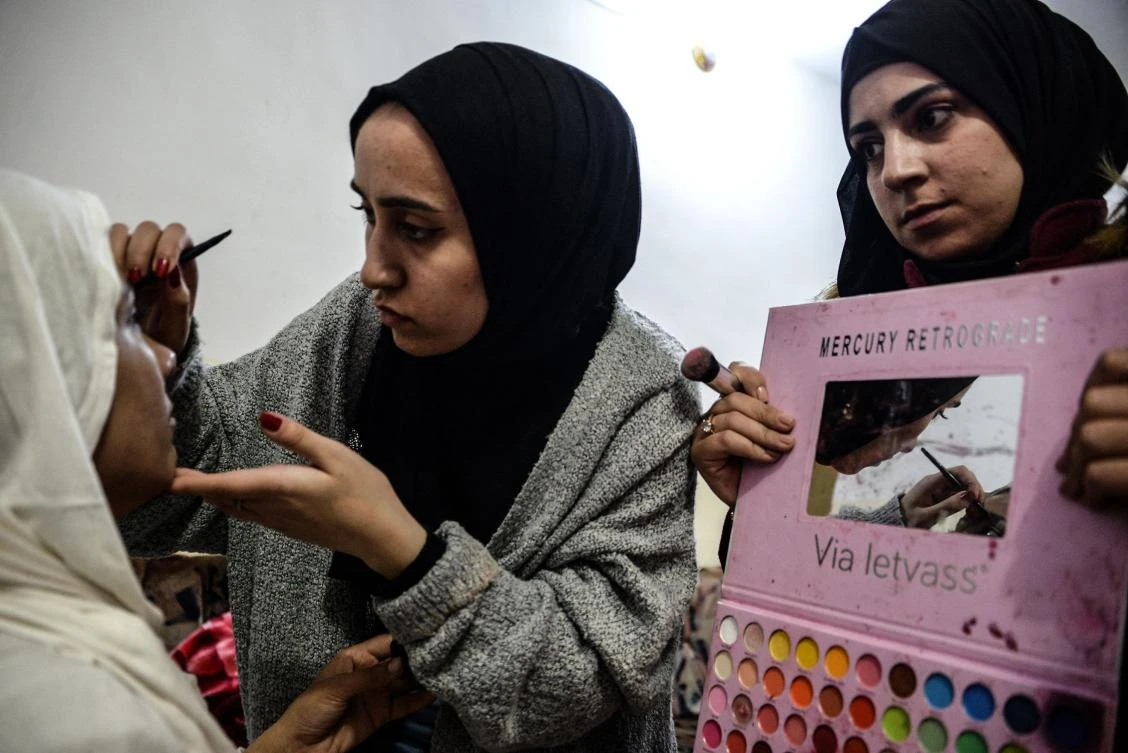 Makeup artists of a film school, prepare an actress dressed as a bride, before shooting a scene in the war-ravaged northern Iraqi city of Mosul, on December 15. (AFP)