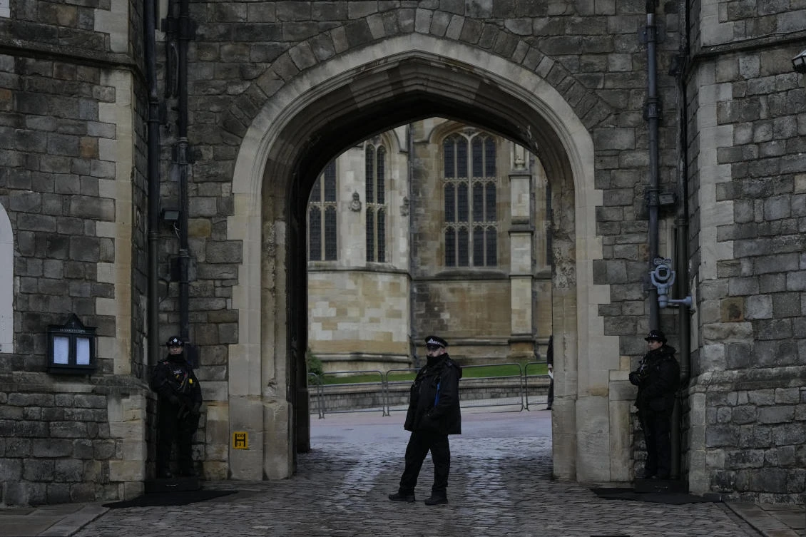 Police guard the Henry VIII gate at Windsor Castle at Windsor, England on Christmas Day, Saturday, Dec. 25, 2021. (AP)
