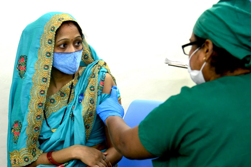 A health worker inoculates a woman with a dose of the Covid-19 coronavirus vaccine at Nair Hospital in Mumbai. (File/AFP)