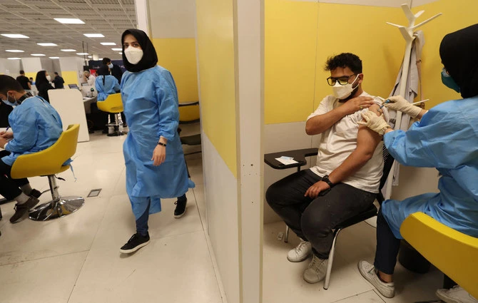 An Iranian health worker inoculates a man at a COVOD-19 vaccination center in Tehran in August . On Sunday, Iran banned the entry of travellers from Britain, France, Denmark and Norway for 15 days. (AFP)
