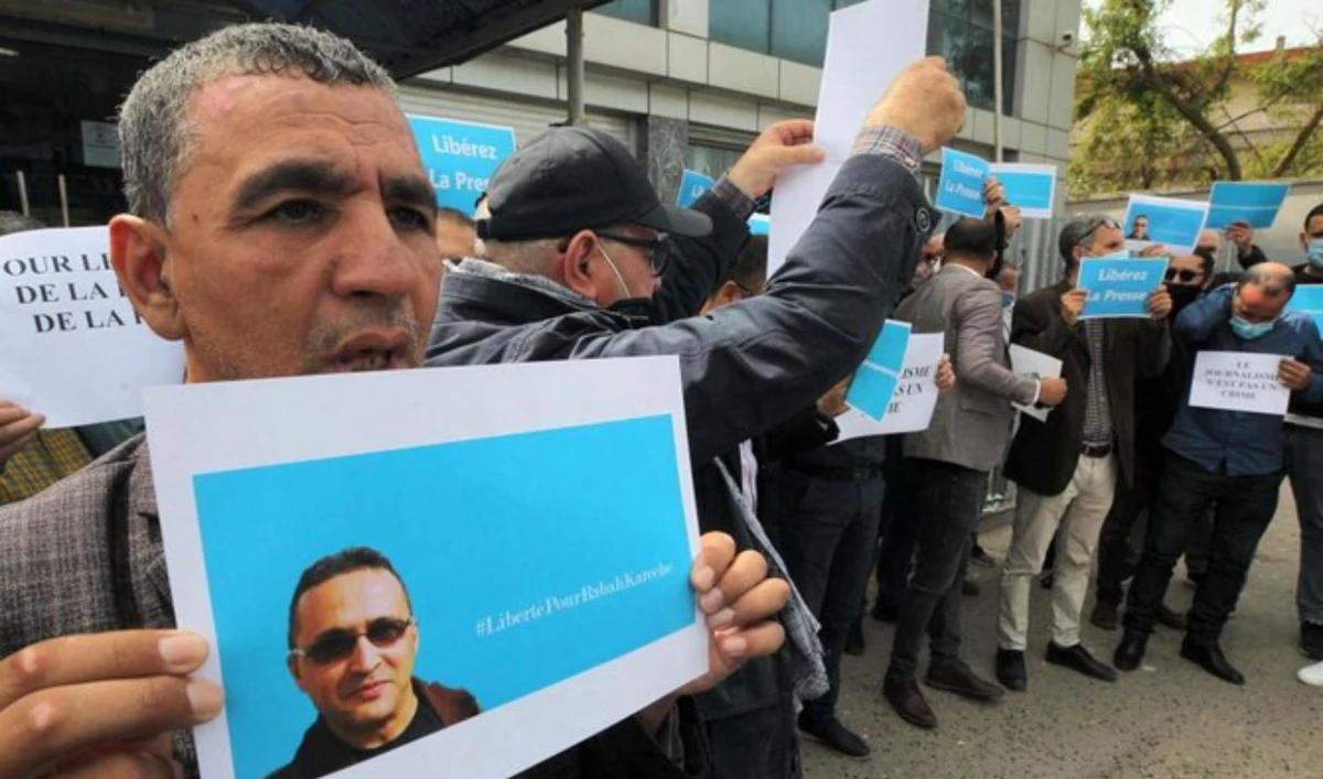 Supporters protest the detention of journalist Rabah Kareche in demonstration on April 25, 2021 in Algiers. (AFP/File)