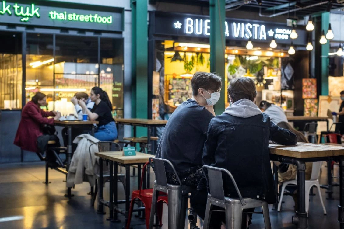 People enjoy their drinks and food in a restaurant in Warsaw, on May 28, 2021. (File/AFP)