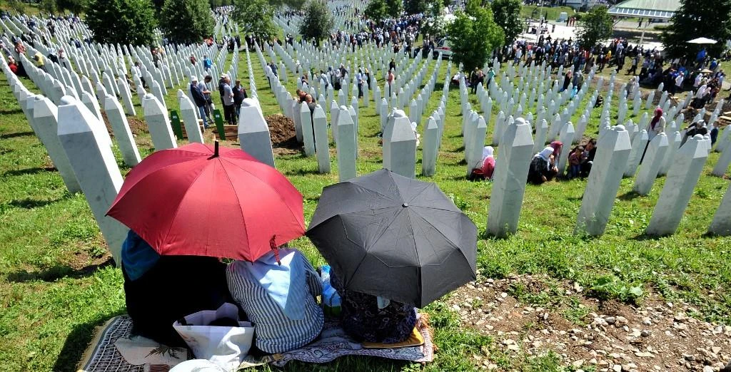 People gather near graves of their relatives at the memorial cemetery of Srebrenica 1995 massacre, in Potocari. (File/AFP)