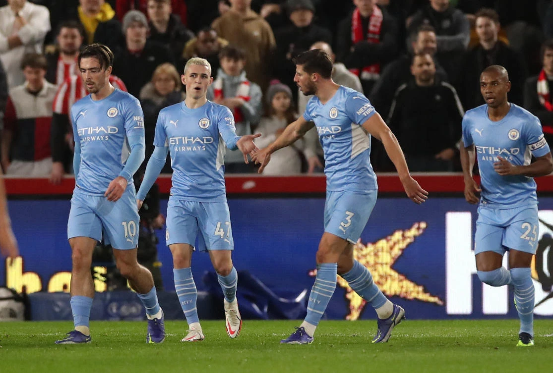 Manchester City’s Phil Foden celebrates scoring their first goal with Ruben Dias during their Premier League match against Brentford at Brentford Community Stadium, London on Wednesday. (Reuters)