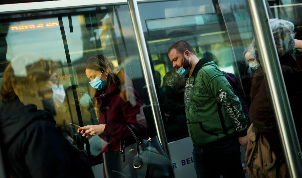 Commuters, wearing protective face masks to prevent the spread of COVID-19, get out of s streetcar in Istanbul, Dec. 27, 2021. (AP)