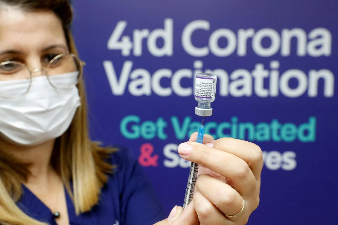 A medic prepres a dose of the Pfizer-BioNTech vaccine against the coronavirus, to be used as a fourth shot. (AFP)