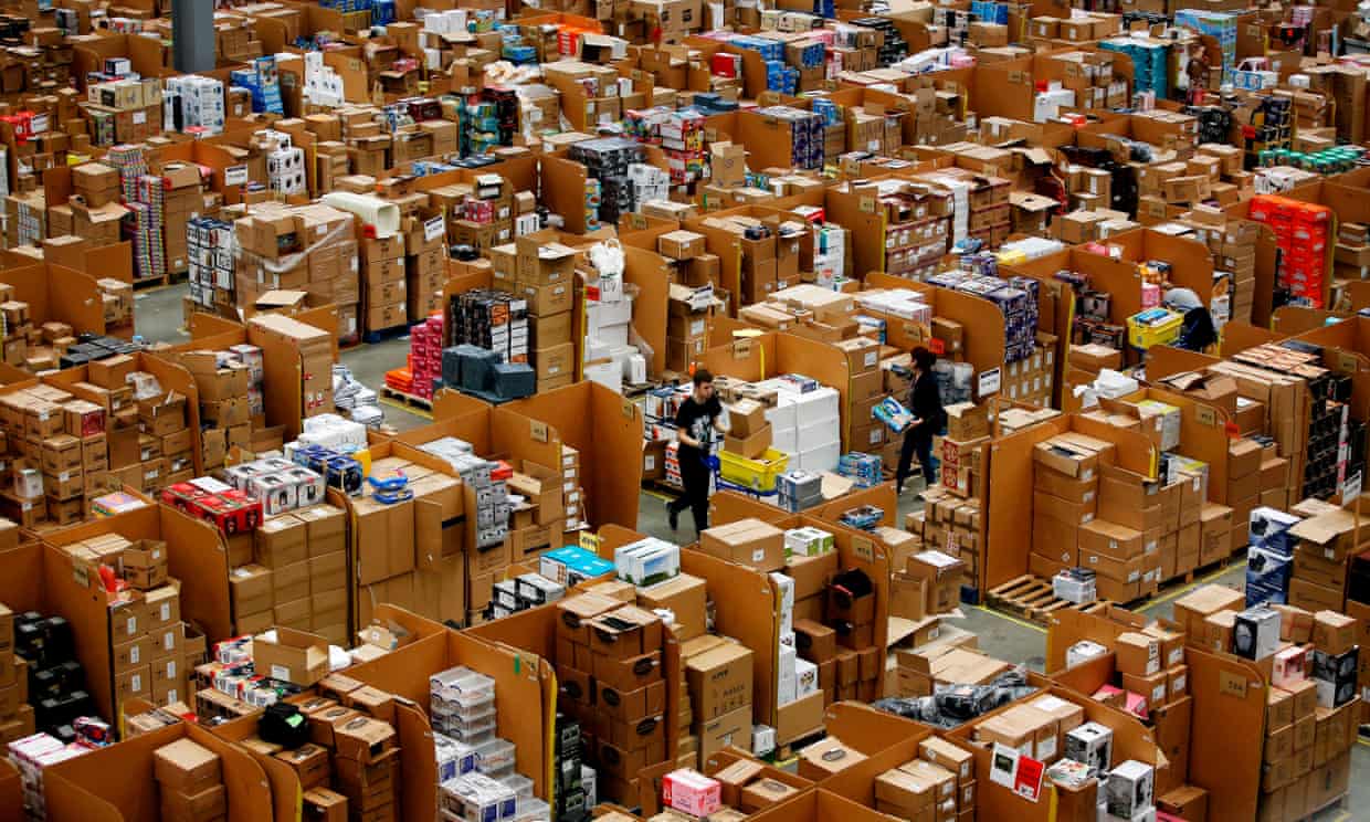 Workers at the Amazon depot in Hemel Hempstead, Hertfordshire, England. The retailer is under pressure to reduce its plastic footprint. (AFP)