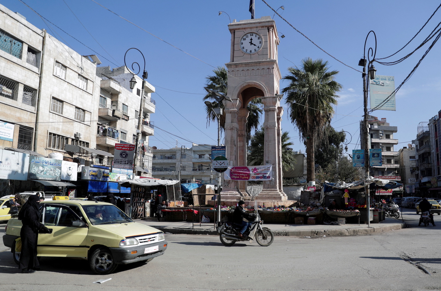 Vehicles and motorbikes drive at a roundabout in the opposition-held city of Idlib, Syria. (File/Reuters)