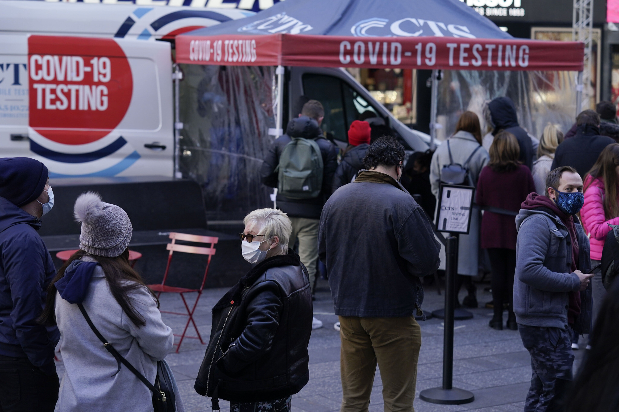 People wait in line at a COVID-19 testing site in Times Square, New York, Dec. 13, 2021. (AP Photo)