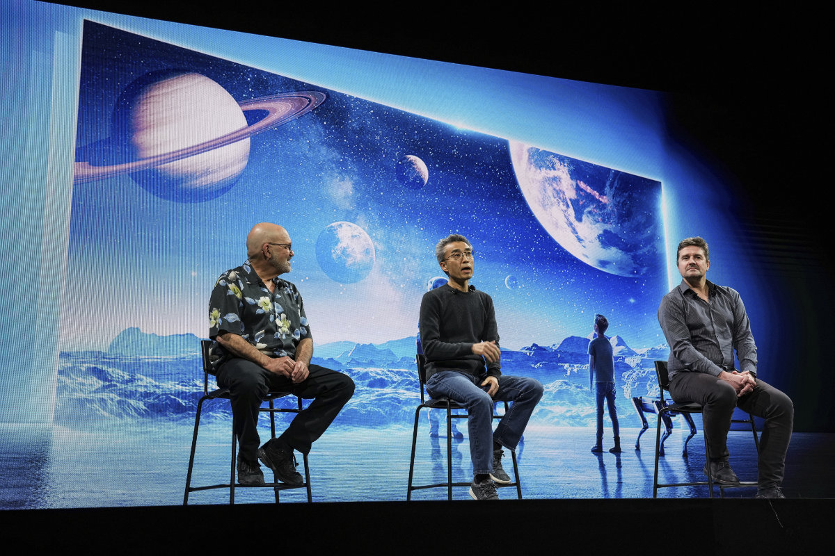 yundai Motor Co. president Chang Song speaks during the CES tech show on Jan. 4, 2022, in Las Vegas while Boston Dynamics chairman and founder Marc Raibert and Microsoft VP of Cloud and AI Ulrich Homann look on. (AP Photo/Joe Buglewicz)