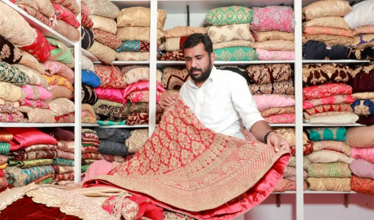 Nasar Tootha folds a bridal gown at his "dress bank" in Thootha village, Malappuram district in India's southern Kerala state. (Photo courtesy: Nasar Tootha)