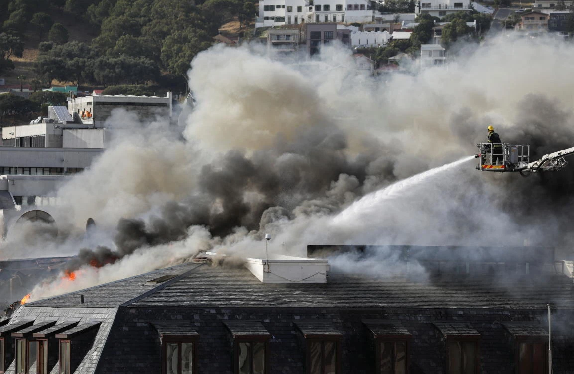 The fire started at around early morning Sunday in the wood-panelled older part of the complex — a section that once housed South Africa’s first parliament. (Reuters)