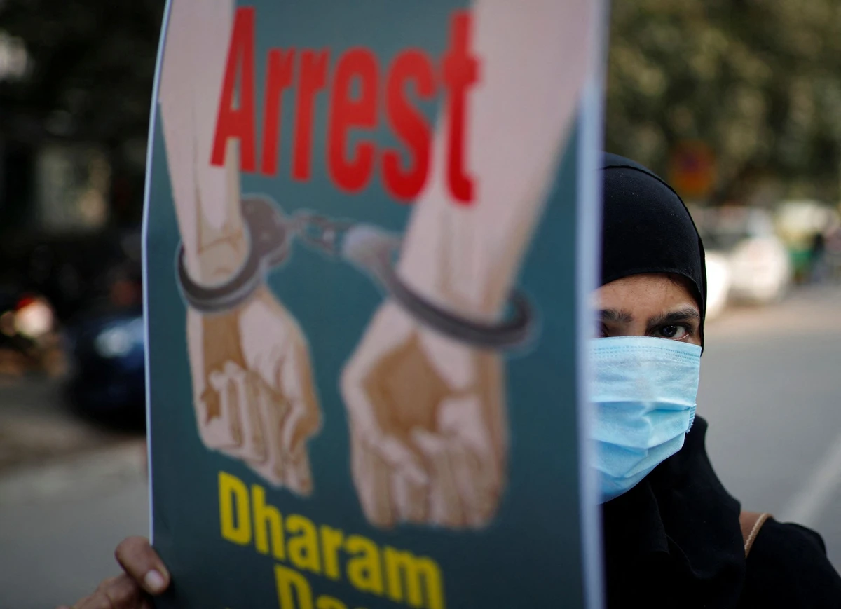 A demonstrator holds a placard during a protest in New Delhi, India, Dec. 27, 2021. (REUTERS/FILE)