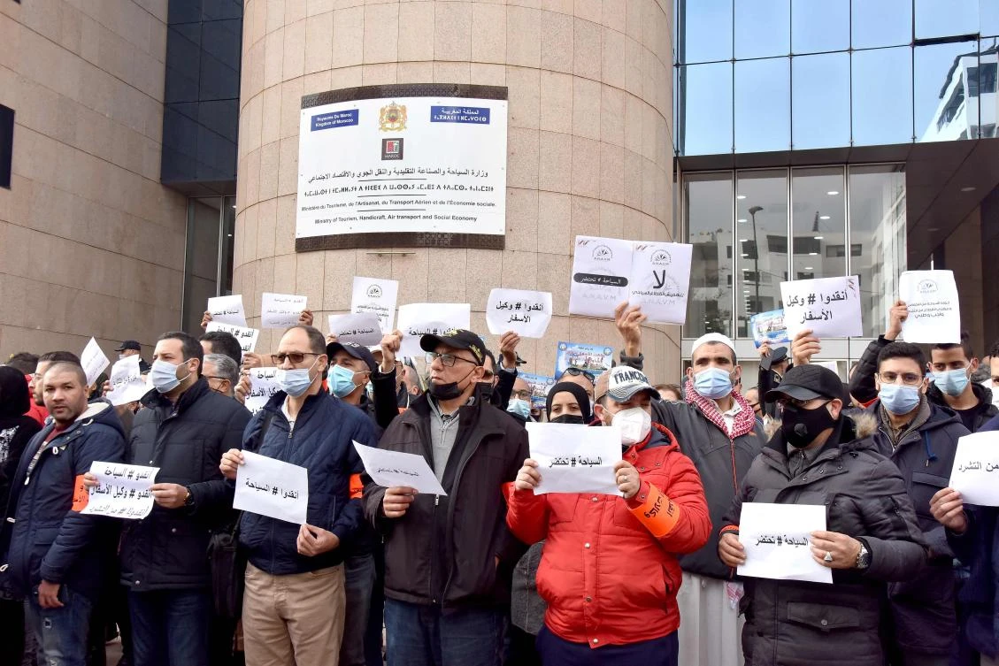 Members of the National Association of Travel Agencies of Morocco protest against borders’ closure during a demonstration in Rabat on Tuesday as the country tries to rein in surging cases of omicron. (AFP)