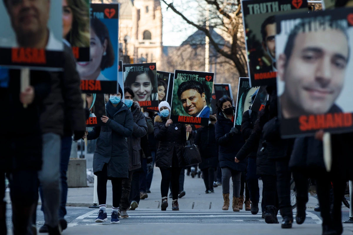 Canadians rally on on Jan. 8, 2021 in Toronto, Ontario , to commemorate the first anniversary of the downing of Ukraine International Airlines flight PS752 near Tehran by Iran's Revolutionary Guards. (AFP)