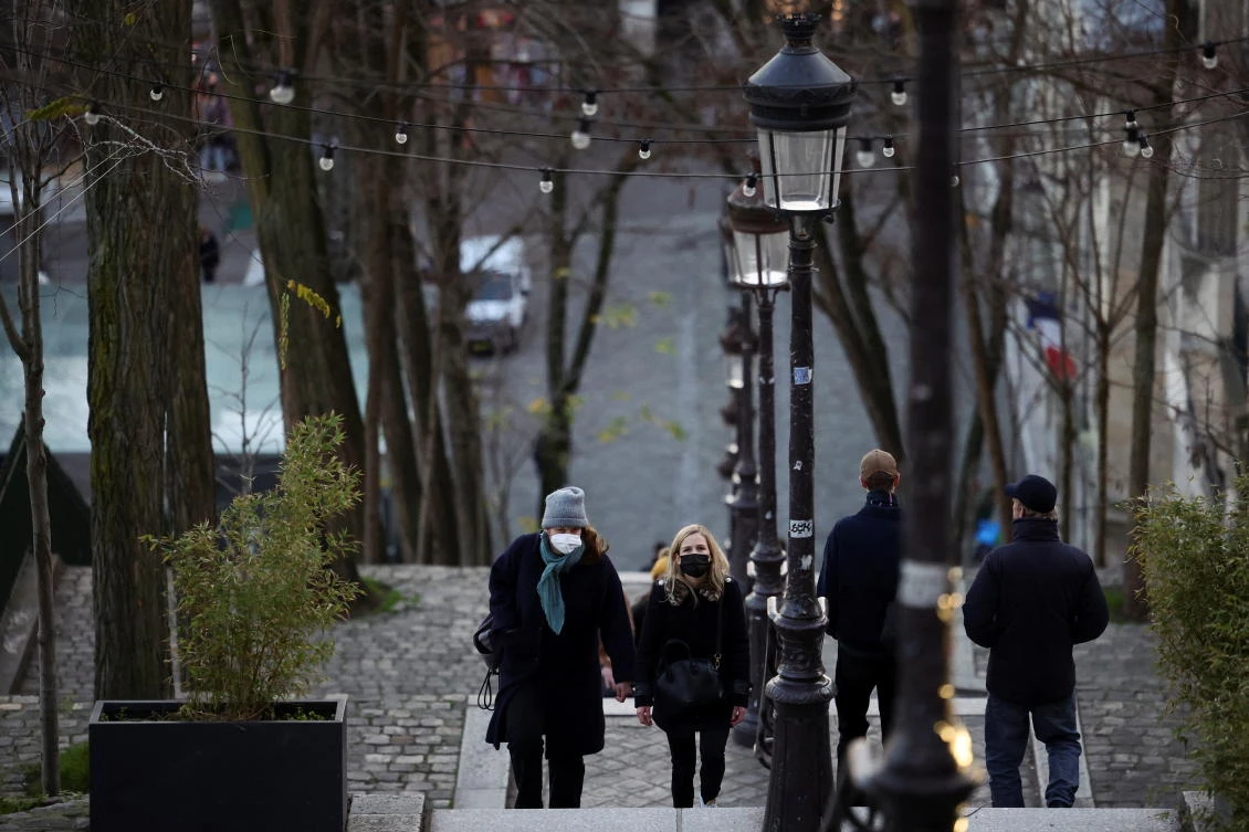 People wearing protective face masks walk in a street at the Butte Montmartre in Paris amid the COVID-19 outbreak in France on Wednesday. (Reuters)