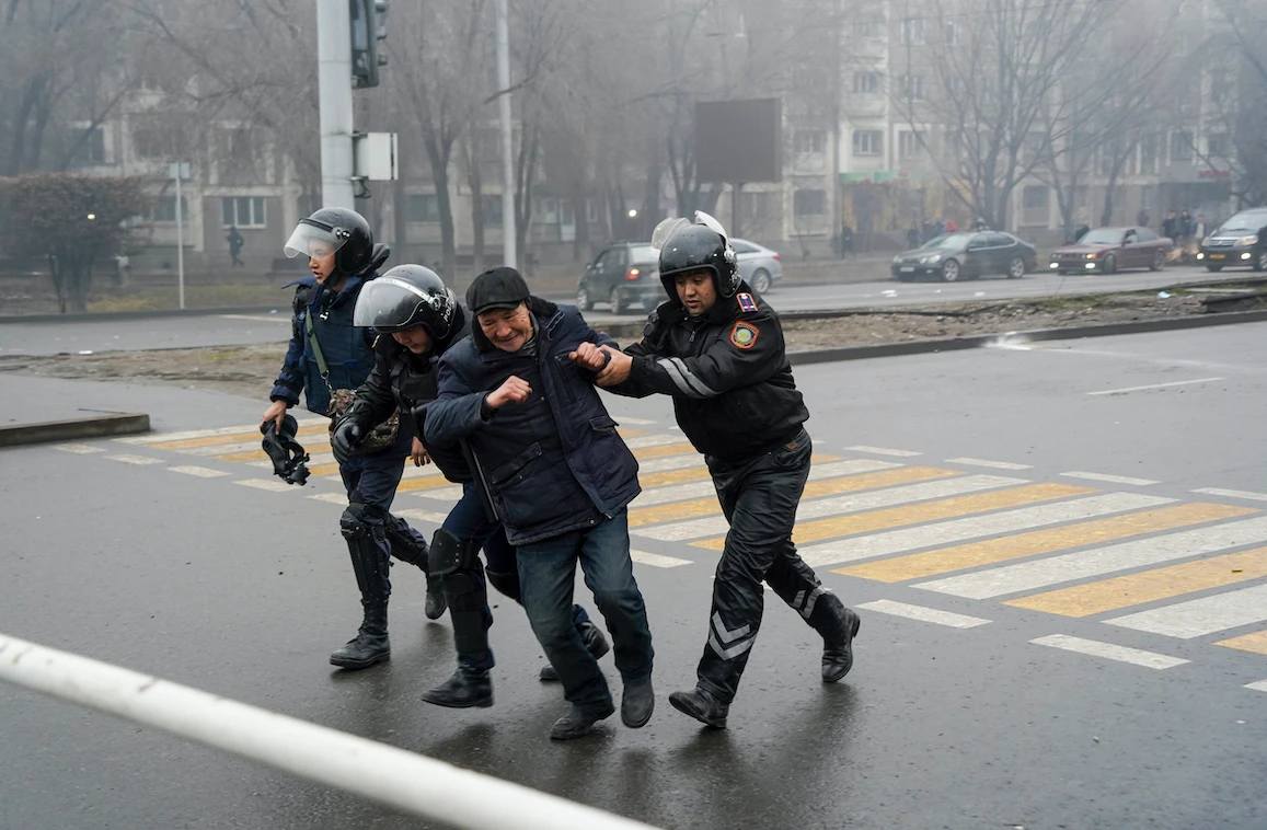 Police officers detain a demonstrator during a protest in Almaty, Kazakhstan, Wednesday, Jan. 5, 2022. (AP Photo/Vladimir Tretyakov)