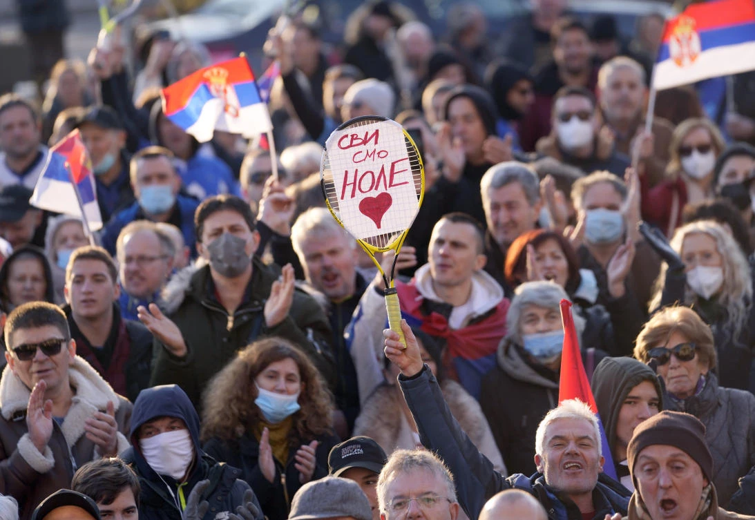 A supporter of Serbia’s Novak Djokovic holds a banner that reads: “We all are Nole (Novak)” during protest in Belgrade on Friday. (AP)