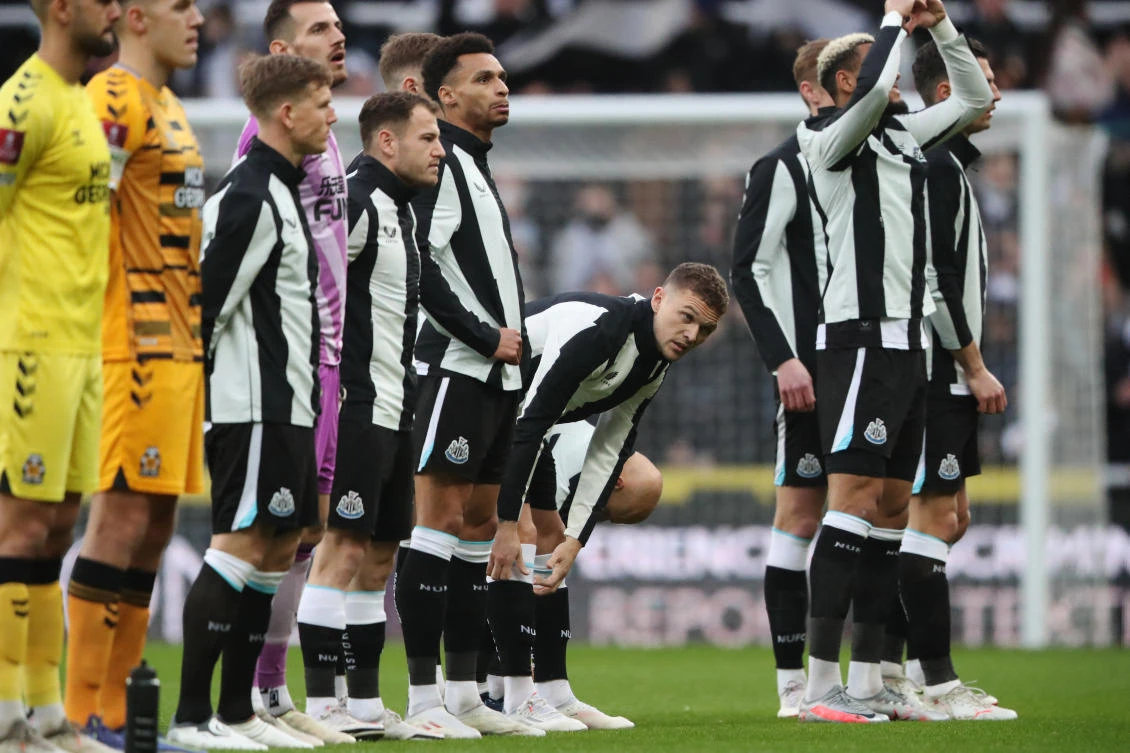 Newcastle United’s Kieran Trippier lines up with teammates before their match against Cambridge United at St. James’ Park on Saturday. (Reuters)
