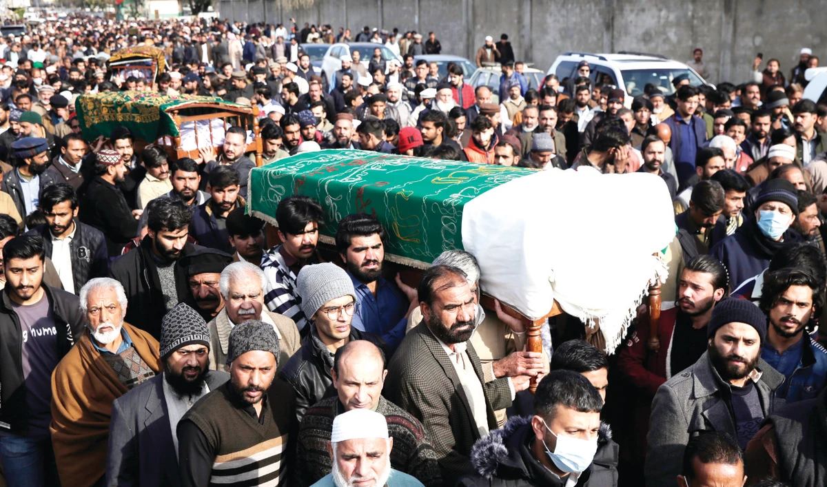 People carry six bodies from one family that were killed after being stuck in their vehicles overnight during a heavy snowstorm in the area of the Murree Hills resort. (AP)