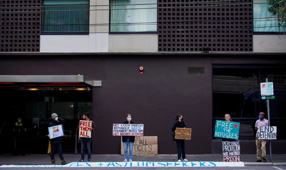 Pro-refugee protestors rally outside the Park Hotel, where Serbian tennis player Novak Djokovic is believed to be held while he stays, in Melbourne, Australia, January 10, 2022. (Reuters)