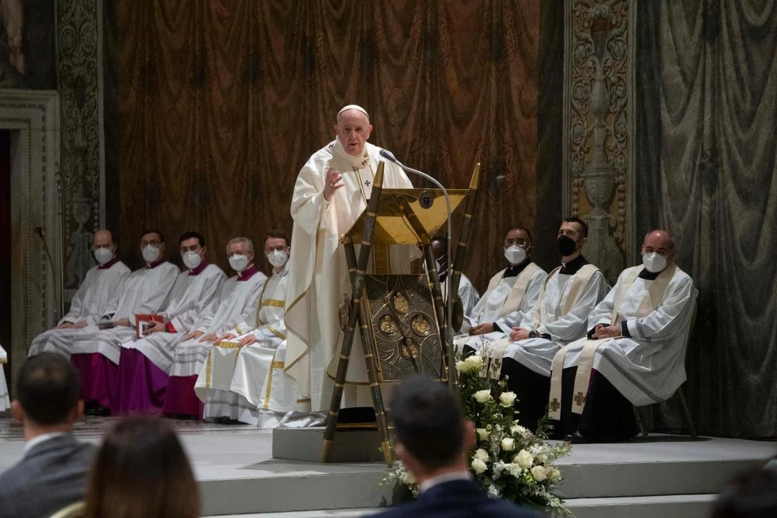 A handout picture taken and released on January 9, 2022 by the Divisione Produzione Fotografica shows Pope Francis baptising a child during the Holy Mass in the Sistine Chapel in the Vatican. (AFP)