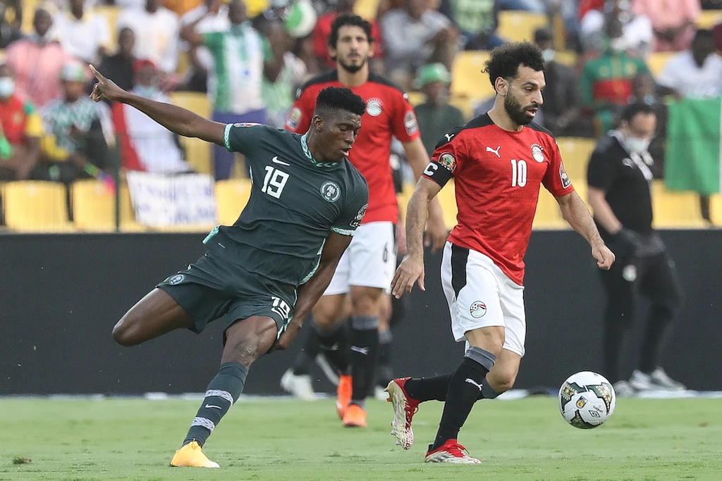 Egypt's Mohamed Salah, right, and Nigeria's Taiwo Awoniyi fight for the ball during the African Cup of Nations Group D soccer match between Egypt and Nigeria in Garoua, Cameroon, Tuesday, Jan. 11, 2022. (AP)