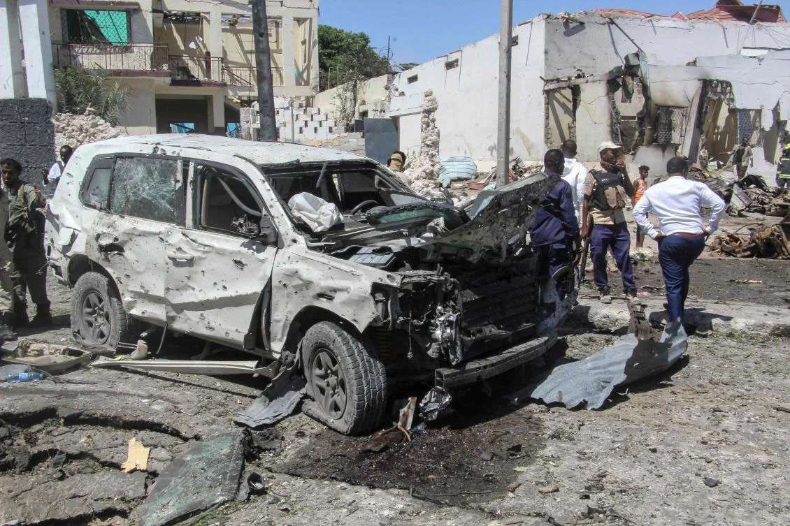 A general view of the scene of a car-bomb explosion in Mogadishu on January 12, 2022 where at least six people were killed and several others wounded in the huge blast that caused devastation in the area along the 21st October road. (AFP)