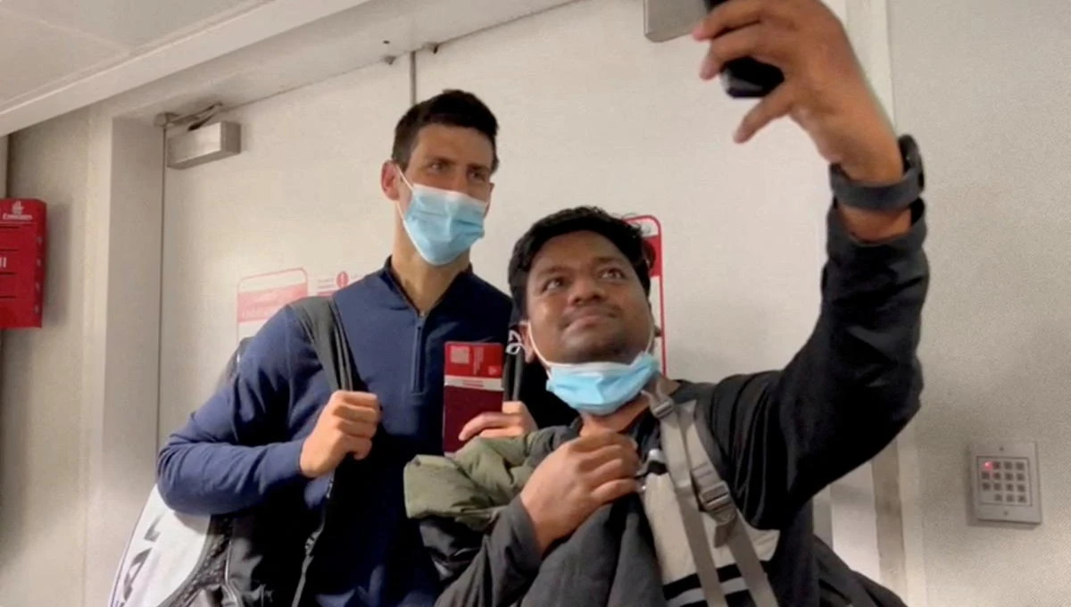 Serbian tennis player Novak Djokovic poses for a selfie after landing at Dubai Airport, in Dubai, United Arab Emirates, January 17, 2022. (Reuters)