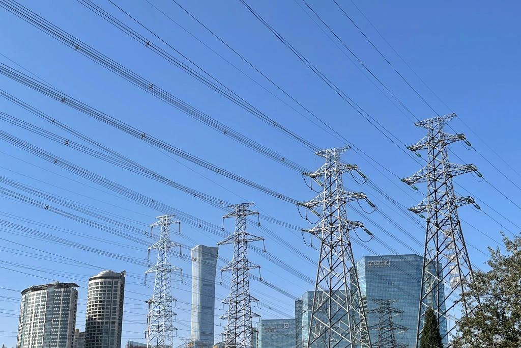 Beijing, China. The China Zun (or CITIC Tower) is seen behind high voltage electric power lines.