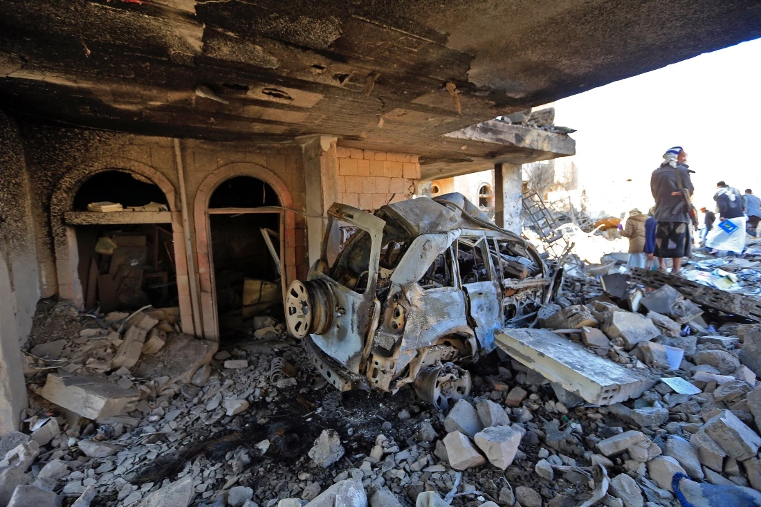 Yemenis inspect the damage following overnight air strikes by the Saudi-led Arab coalition targeting the Houthi-held capital Sanaa, on Jan. 18. (AFP)